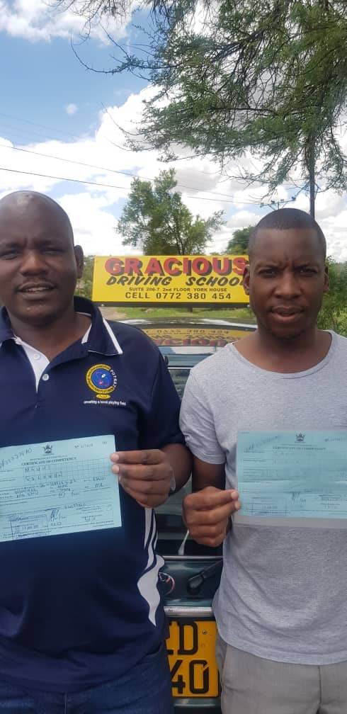 Two more graduates with their certificates of competency