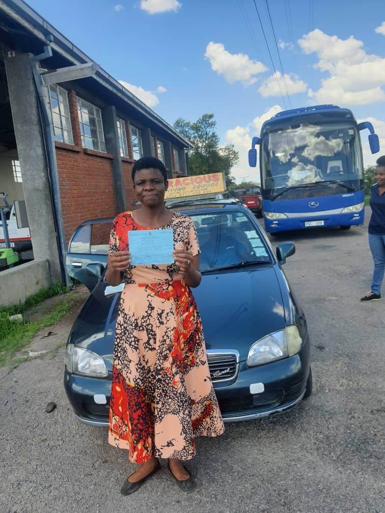 A proud graduate with her certificate of competency